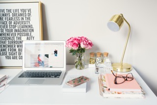 writing desk, laptop, lamp, flowers