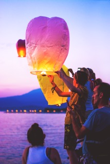 family launching candle balloon