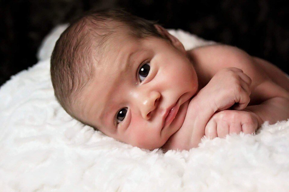 newborn baby staring at camera