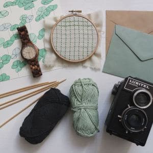 Watch, knitting, letters, and camera collection.