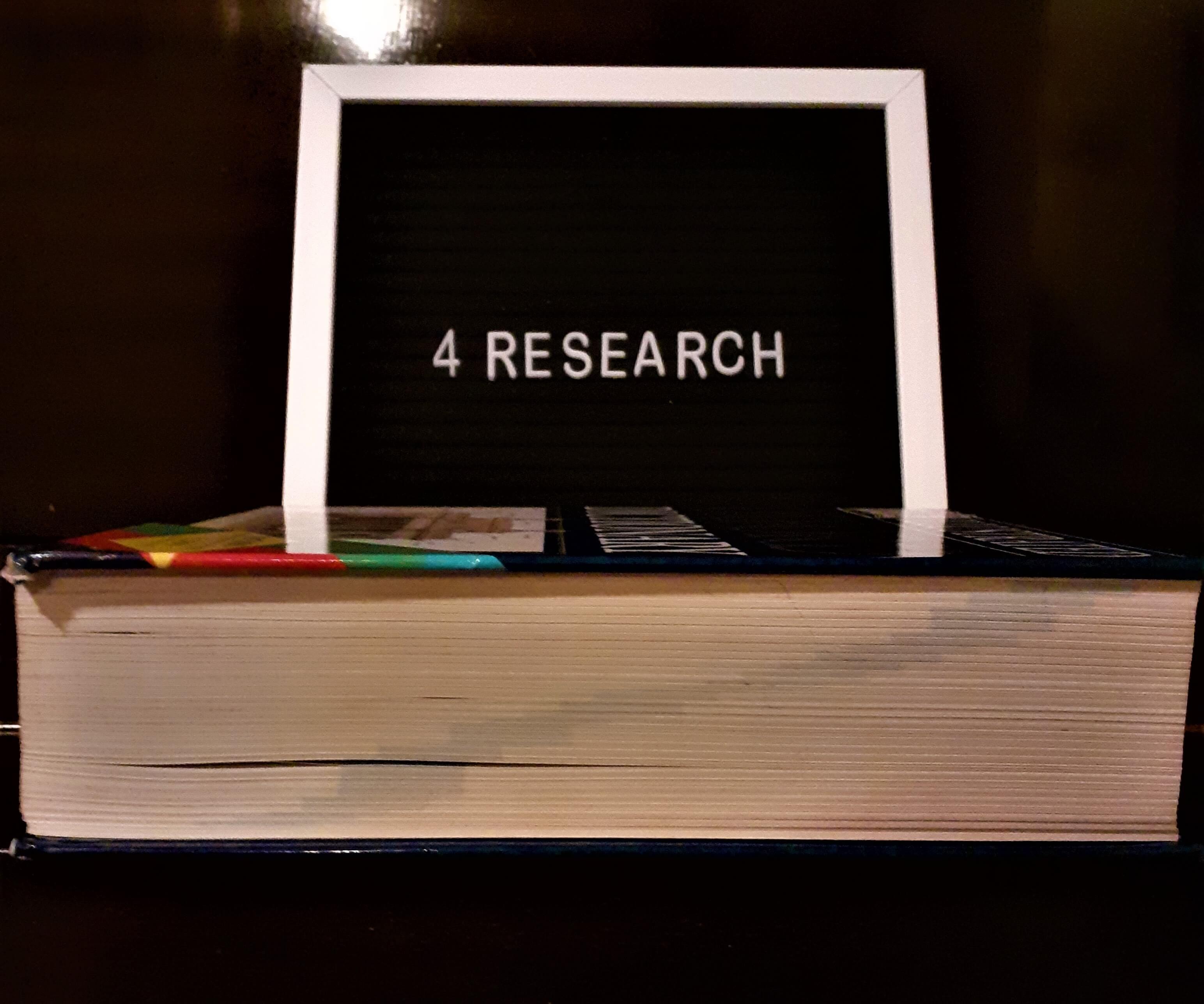 research sign with reference book