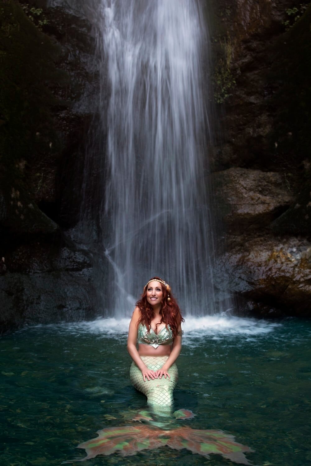 Mermaid sitting in waterfall